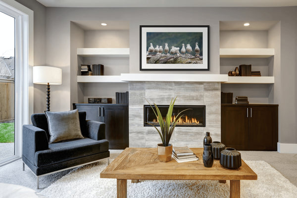 Modern living room with a fireplace, shelves, and a coffee table.