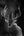 Black and white photo of a deer with large antlers against a dark background