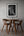Dining area with a table and chairs, and a framed black and white deer print on the wall.
