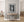 Framed black and white artwork of a wolf on a rock wall above a wooden console table.